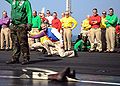US Navy 081201-N-7571S-003 Sailors gather to support former air boss, Capt. Carl Conti as he launches his boots off the ship's flight deck.jpg